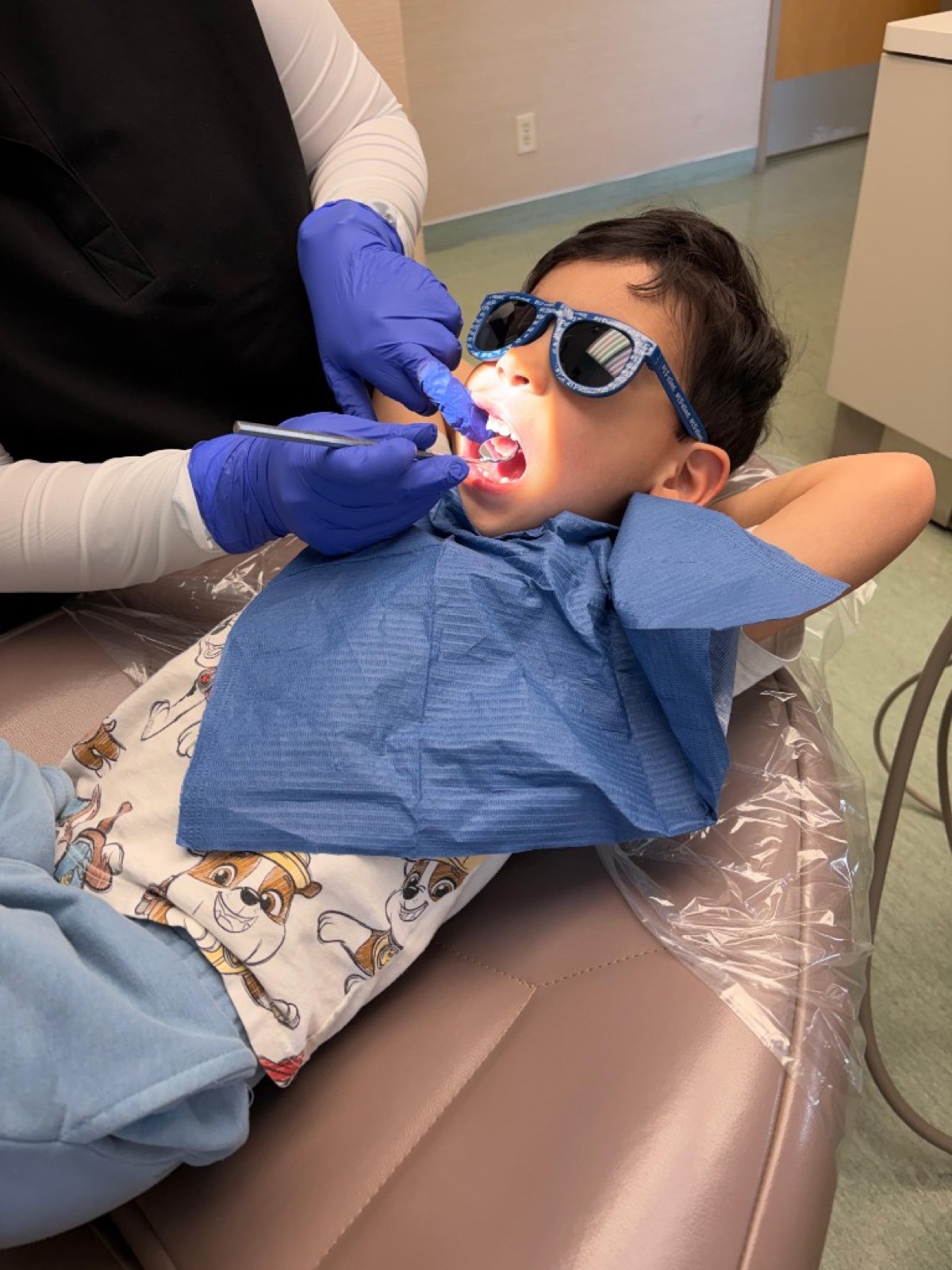 Young patient receiving a gentle dental exam at Crestwood Dental Clinic