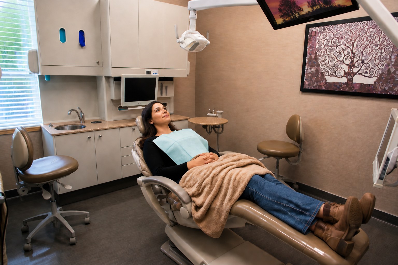 Relaxed adult patient watching TV during a comfortable dental visit